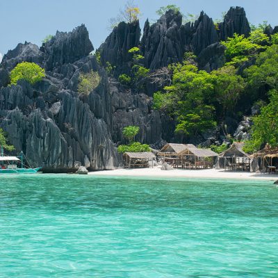 Small beach with few cabins and clear water of the Phillipines