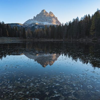 Tre Cime di Lavaredo reflecting in Antorno Lake in Dolomites
