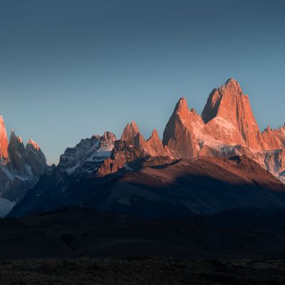 Panoramic view of Cerro Torre and Fitz Roy mountain ranges at sunrise