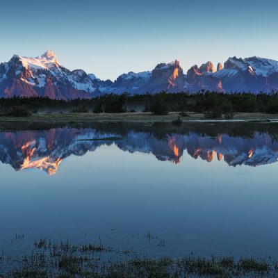 Reflection of Torres del Paine mountain range at sunrise